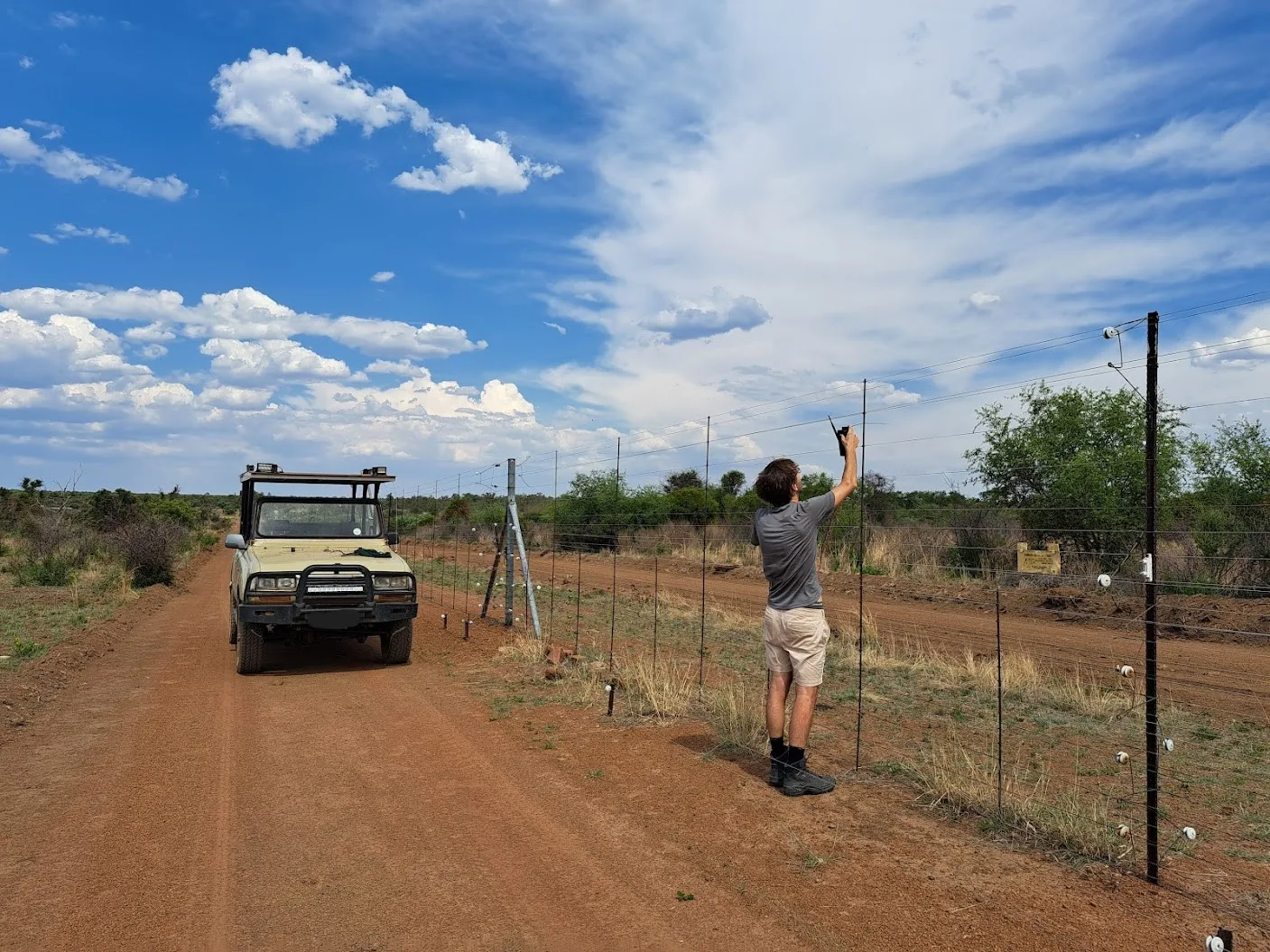 Field technician installing a Safora sensor on an electric fence
